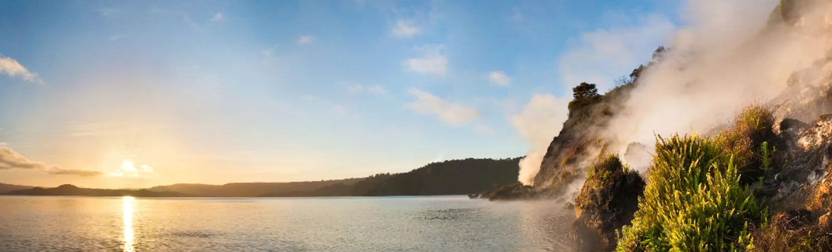 Geothermal steam rising from Fumerole Bay at Lake Rotomahana in Waimangu Volcanic Valley, Rotorua New Zealand