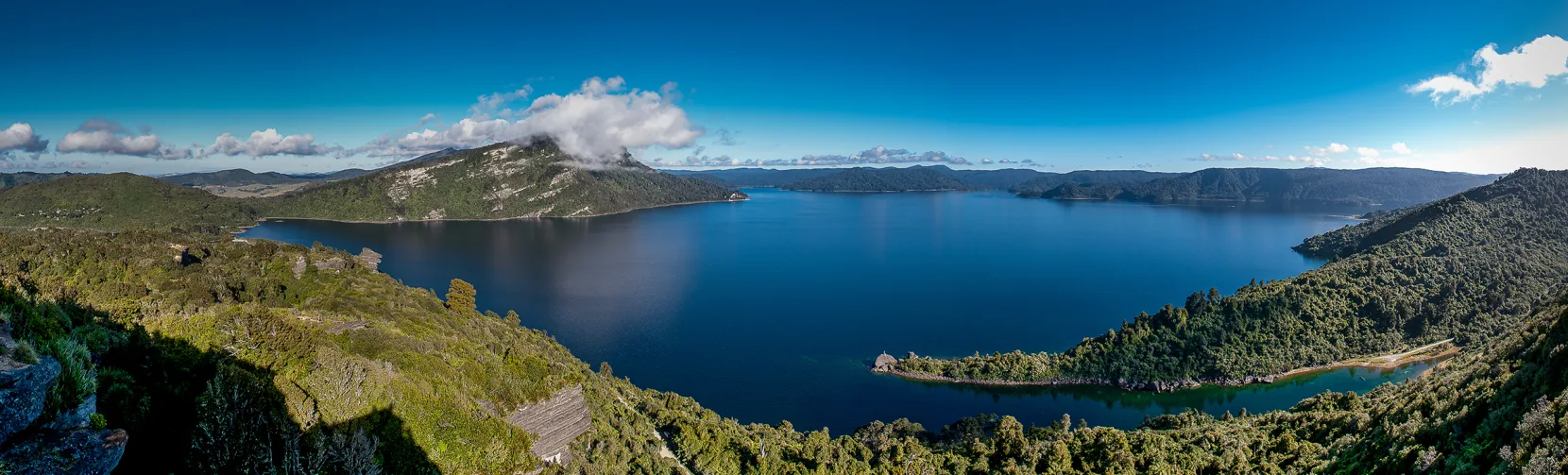 Panoramic view of Lake Waikaremoana in Te Urewera surrounded by native forest and mountains, a popular multi-day hiking and walking track in Hawke’s Bay, New Zealand