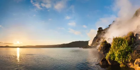 Geothermal steam rising from Fumerole Bay at Lake Rotomahana in Waimangu Volcanic Valley, Rotorua New Zealand