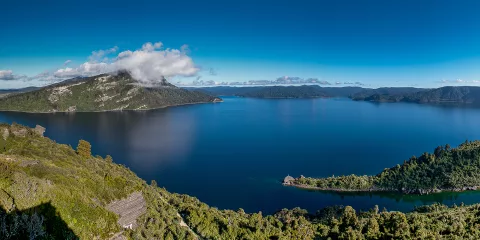 Panoramic view of Lake Waikaremoana in Te Urewera surrounded by native forest and mountains, a popular multi-day hiking and walking track in Hawke’s Bay, New Zealand