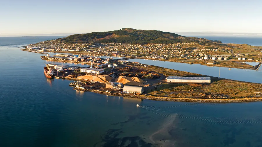 Aerial view of Bluff township and Bluff Hill (Motupōhue) with harbour and coastline, famous for the Bluff Oyster Festival in Southland, New Zealand