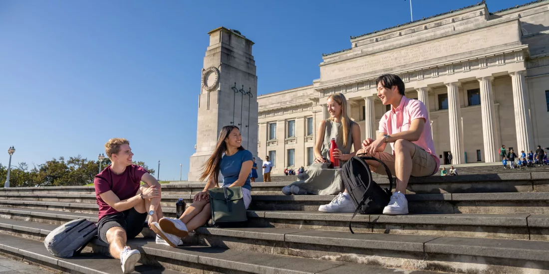 Friends sitting outside Auckland War Memorial Museum