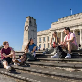 Friends sitting outside Auckland War Memorial Museum