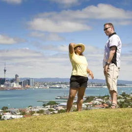 Couple enjoying Auckland skyline and harbour views from Devonport hill
