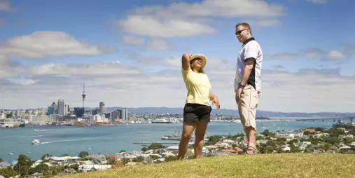 Couple enjoying Auckland skyline and harbour views from Devonport hill