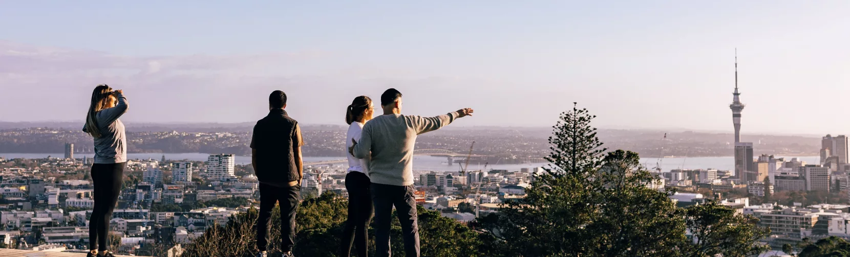 Group viewing Auckland city skyline from Mount Eden
