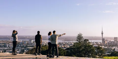Group viewing Auckland city skyline from Mount Eden