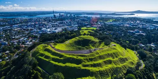 Aerial view of Mount Eden volcanic crater and Auckland city skyline