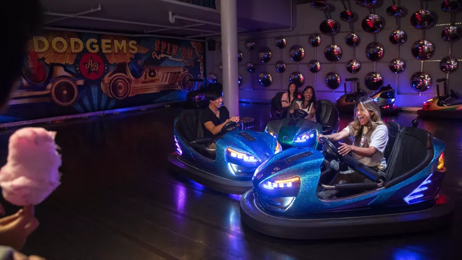 Friends riding bumper cars in Newmarket Auckland