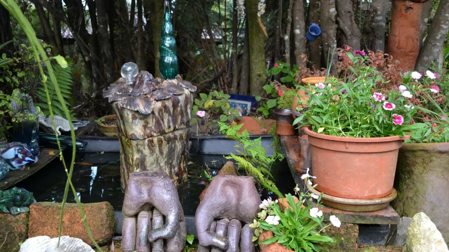 Artistic sculpture nestled in native bush along the Driving Creek Railway in the Coromandel