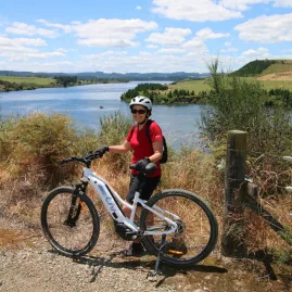 Cyclist taking a break at a stunning viewpoint overlooking the Waikato River