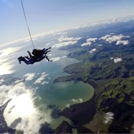 Tandem skydive over sparkling water and lush green countryside near Auckland