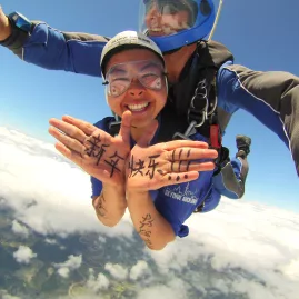 Skydiver sending a handwritten Chinese New Year greeting during a jump over Auckland