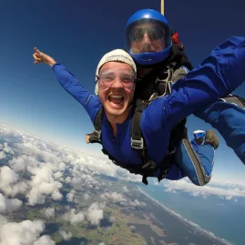 Happy man enjoying a tandem skydive over Auckland’s east and west coastlines