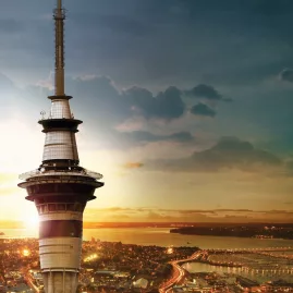 Close-up of the Sky Tower in Auckland with sunset colours in the background