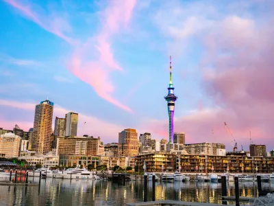 Auckland city skyline and Sky Tower reflecting on marina