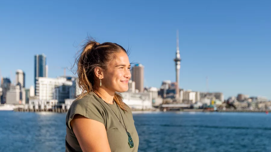 Woman smiling with Auckland skyline in background