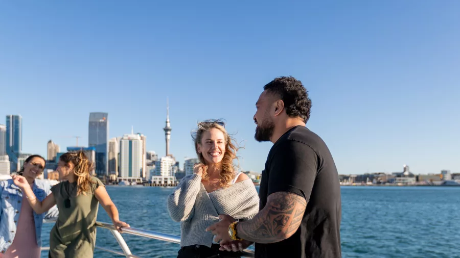 Friends on boat with Auckland skyline in background