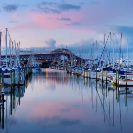 Yachts at sunset in Westhaven Marina with Auckland Harbour Bridge