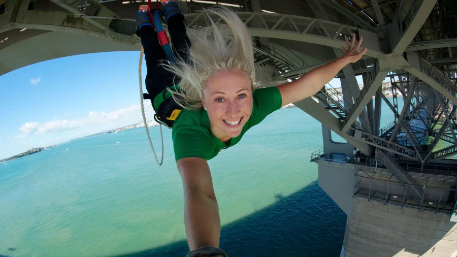Woman bungy jumping from Auckland Harbour Bridge, AJ Hackett Bungy