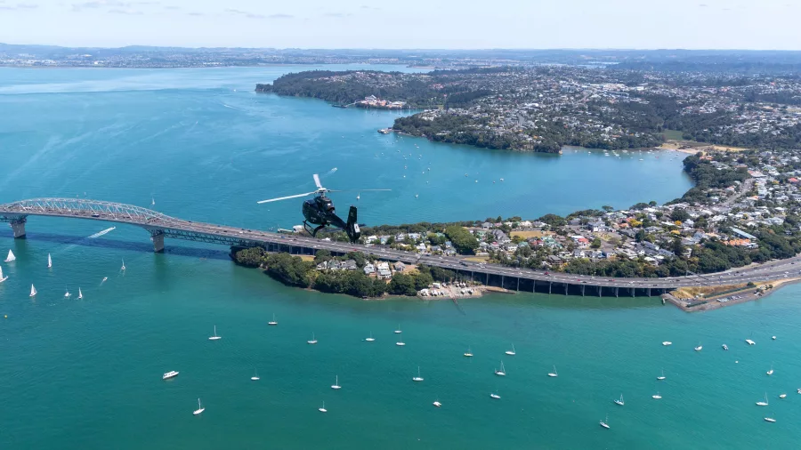 Aerial view of Auckland Harbour Bridge with helicopter