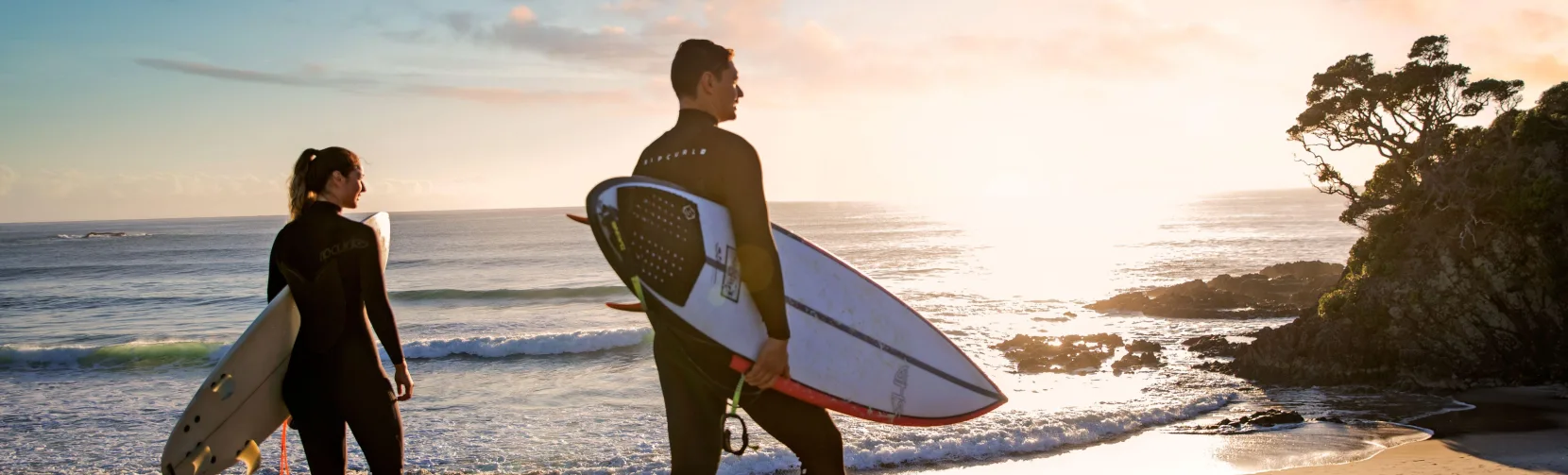 Surfers at Medlands Beach Great Barrier Island