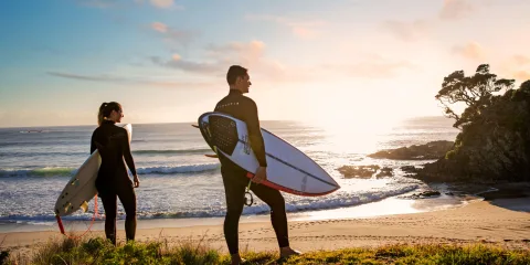 Surfers at Medlands Beach Great Barrier Island