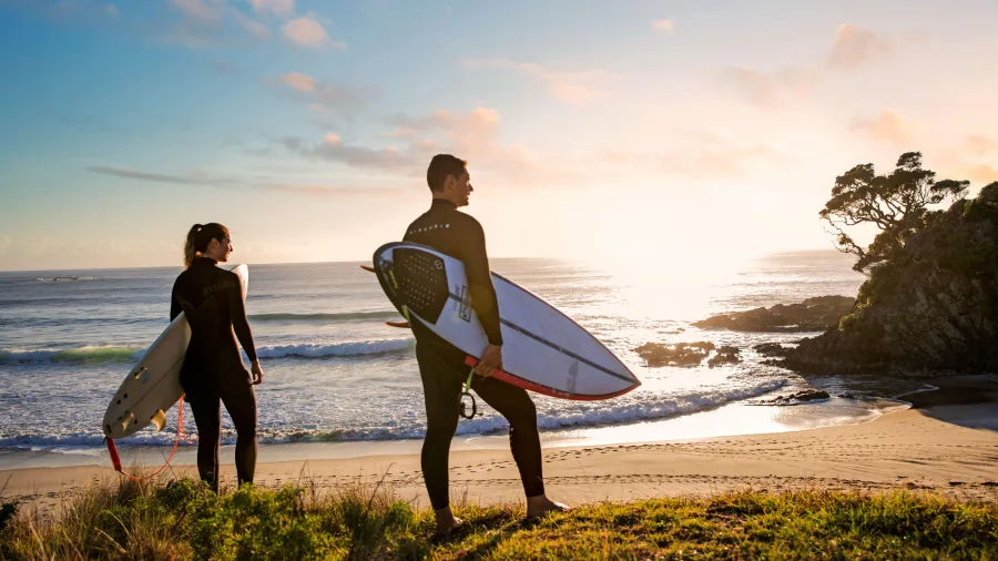 Surfers at Medlands Beach Great Barrier Island
