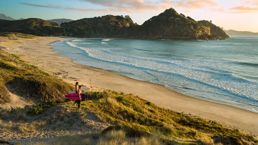 Surfers on Medlands Beach Great Barrier Island