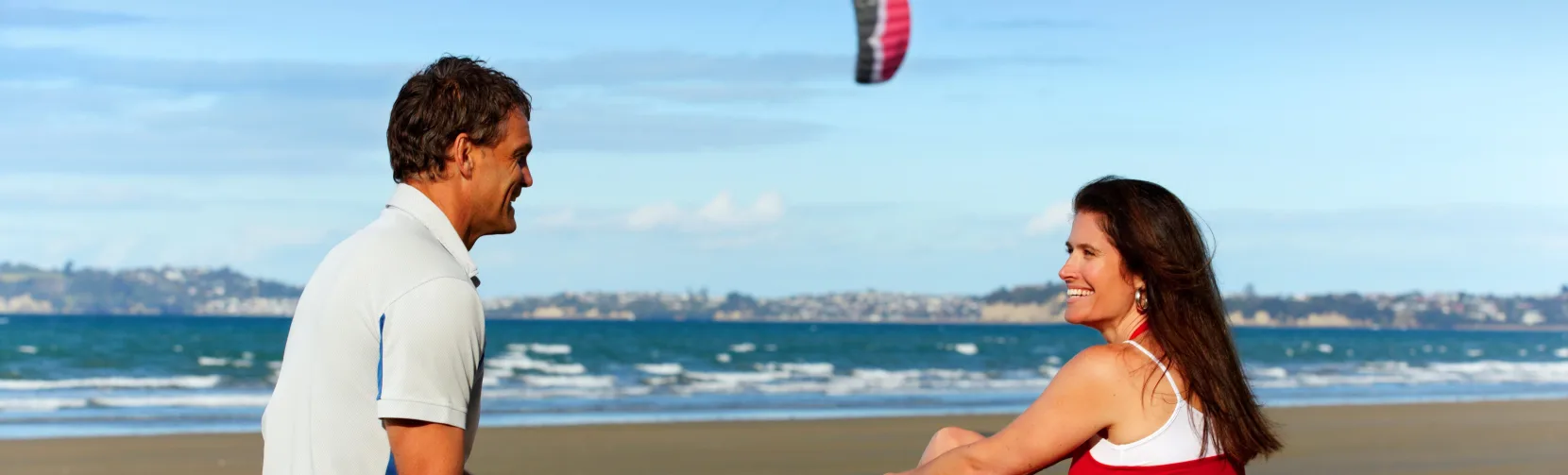 Couple eating fish and chips at Orewa Beach