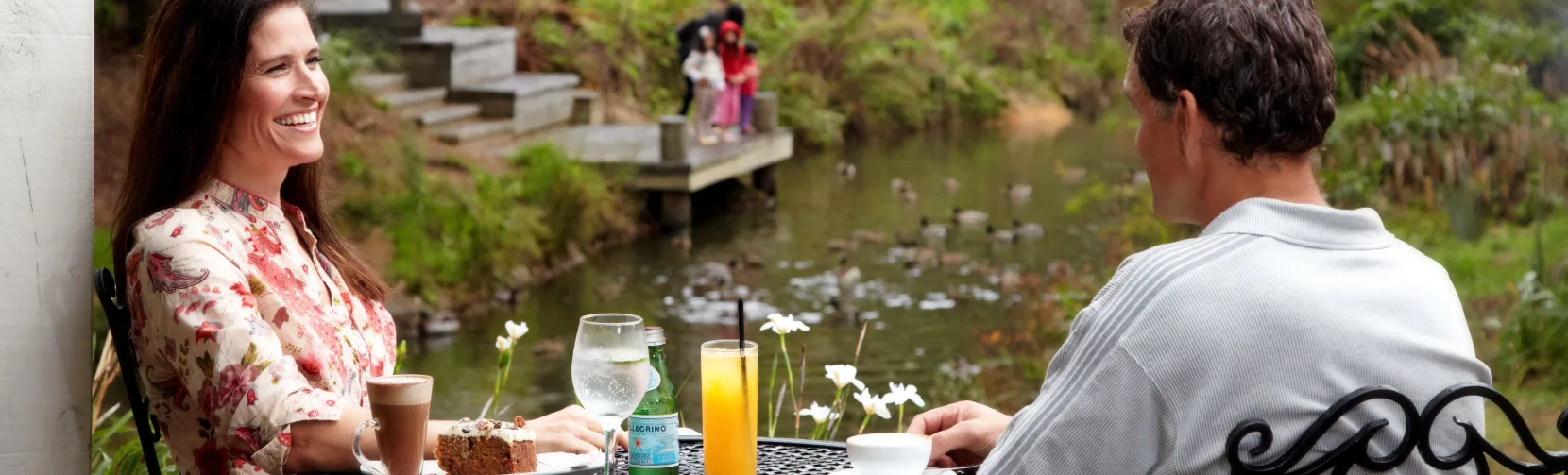 Couple enjoying coffee and cake in Matakana
