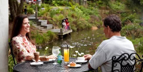 Couple enjoying coffee and cake in Matakana