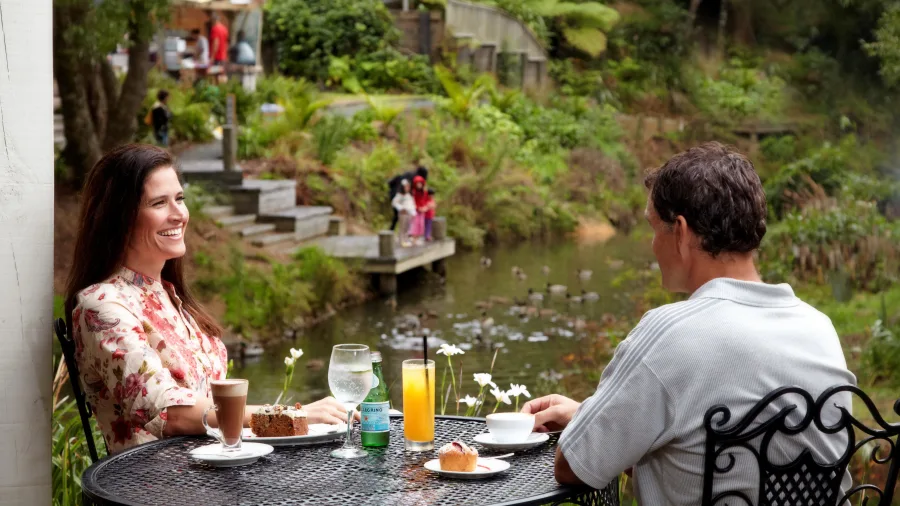 Couple enjoying coffee and cake in Matakana