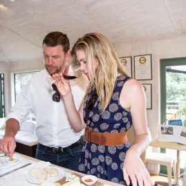 Guests sampling wines at a boutique vineyard on Waiheke Island during a private tour with scenic views and a vineyard lunch