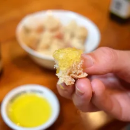 A guided Waiheke Island olive oil tasting experience with Ananda Tours, featuring artisan oils and fresh bread on a rustic wooden table.