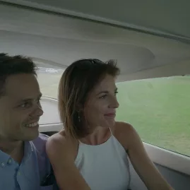 Couple sitting together inside a light aircraft with green fields outside, enjoying a scenic flight to Waiheke Island for a vineyard tour