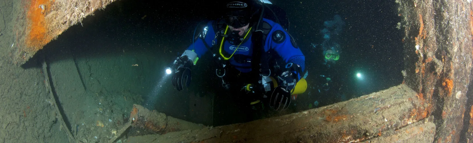 Scuba diver explores the MS Mikhail Lermontov shipwreck during a New Zealand Diving charter in Marlborough Sounds.