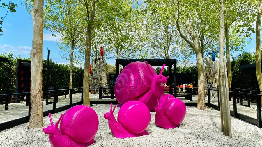 Bright pink snail sculptures displayed in the outdoor gardens at Sculptureum in Matakana, New Zealand.
