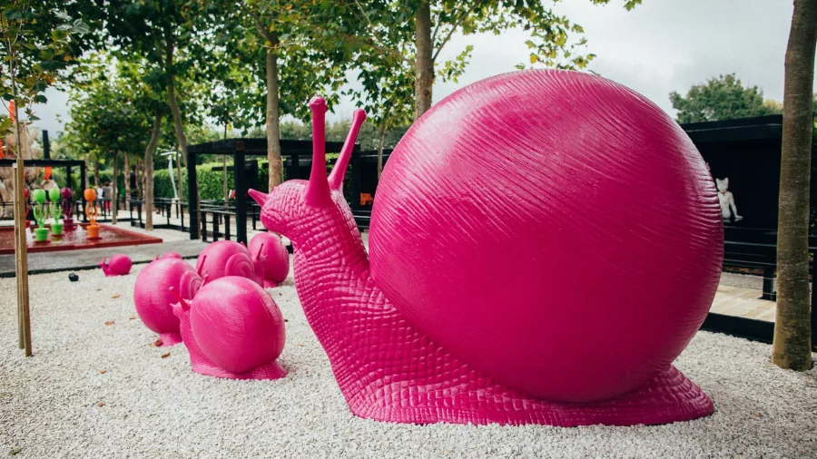 Large pink snail sculptures featured in the outdoor art gardens at Sculptureum, Matakana, New Zealand.