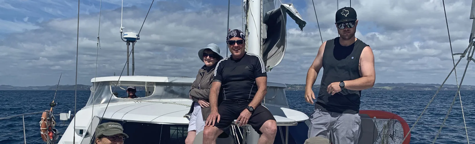 Yacht sailing across calm blue waters under clear skies