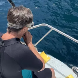 Guest about to go snorkelling in clear blue water during a sailing excursion