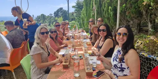 Group enjoying lunch and wine tasting at Casta Miro vineyard during a Waiheke Island wine tour in New Zealand