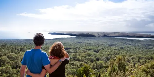 Couple overlooking Hauraki Gulf from Rangitoto Island summit
