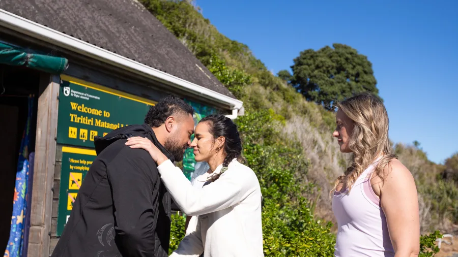 Man and woman share hongi greeting on Tiritiri Matangi Island
