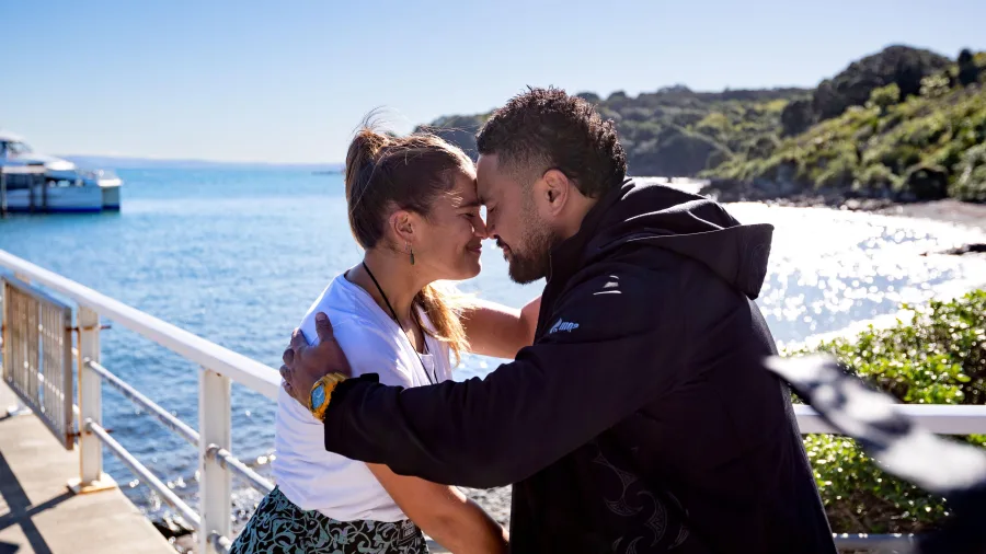Man and woman hongi on Tiritiri Matangi Island wharf
