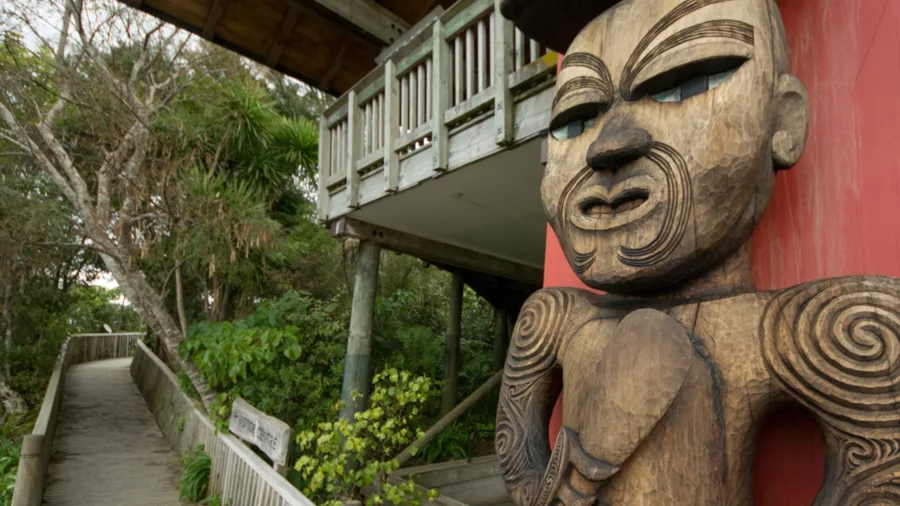 Close-up of carved Māori pou outside Arataki Visitor Centre, Waitākere Ranges