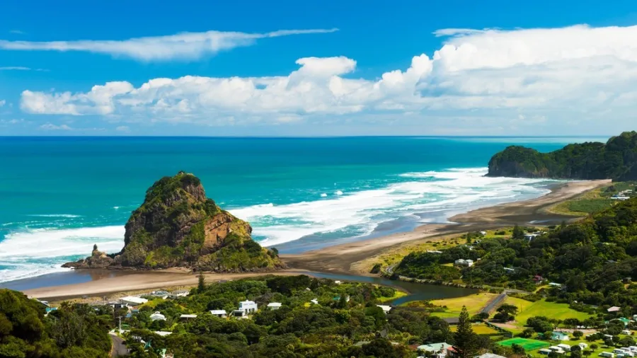 Sunset view over Piha Beach with Lion Rock in Auckland