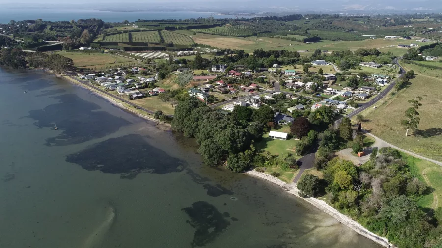 Aerial view of Ongare Point coastline with surrounding orchards and rural landscape