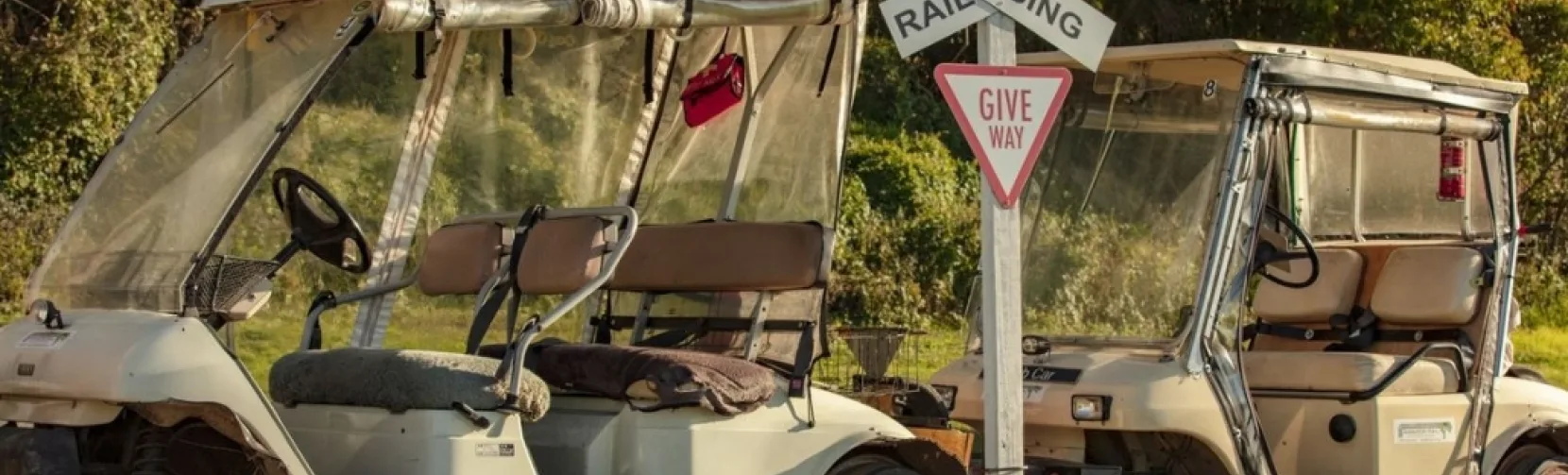 Self-drive rail carts crossing a railway intersection on the Awakeri Rail Adventures line