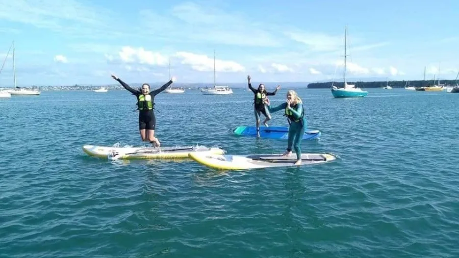 SUP paddlers jumping off their boards into Tauranga Harbour